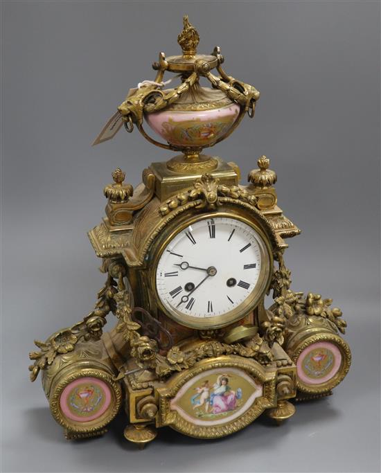 A 19th century Louis XVI style ormolu mantel clock inset with porcelain panels height 38cm